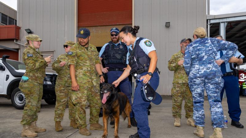 NSW Police Officer Constable Amanda Bliss pets military working dog, Nitro, during a Joint Military Police Unit Sydney community engagement day at RAAF Base Richmond.