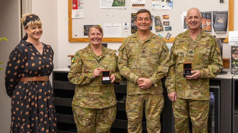 Army Major Wendi McAdie and Warrant Officer Class One Andrew McAdie are presented their Federation Star medals by Major General Michael Krause alongside their daughter, Clancy McAdie.