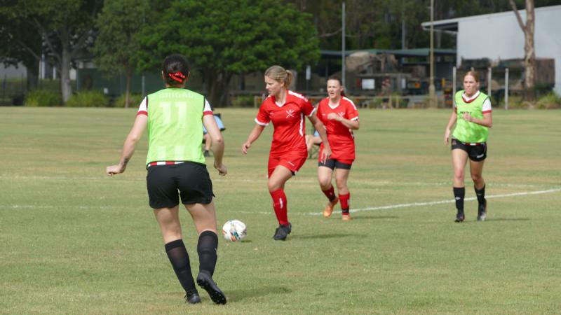 Army soldier Sapper Casey Denais, a combat engineer from 11th Engineer Regiment and most valuable player of the women's team, leads her team in the annual ADF Army Football (Soccer) Championships.