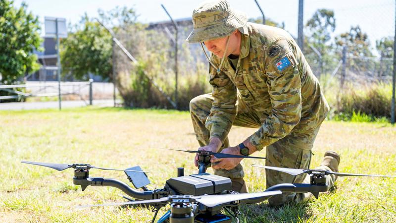 Australian Army soldier Corporal Sam Kelly prepares an uncrewed aerial system with a mounted Light Detection and Ranging unit for a test flight at Gallipoli Barracks, Brisbane. 