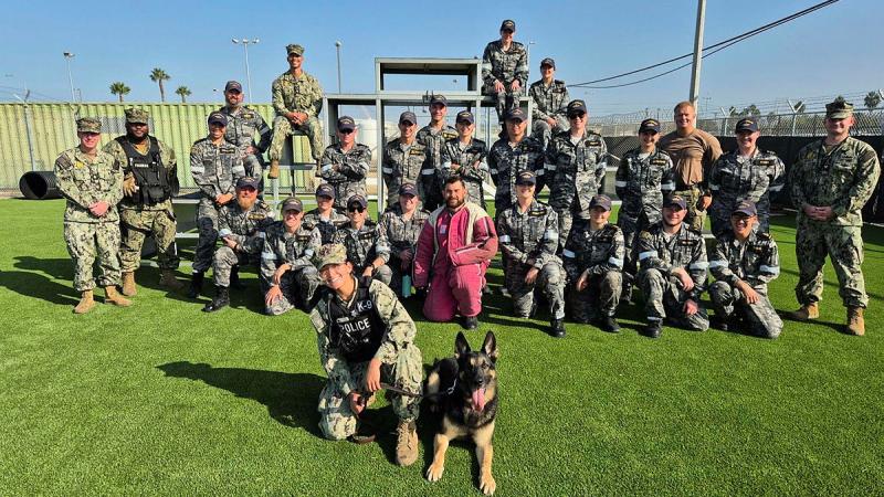 The crew of HMAS Brisbane at the Naval Base San Diego Military Working Dog Kennels where they observed an obedience course certification, and practised a simulated hostile incident response a part of the interchangeability deployment.