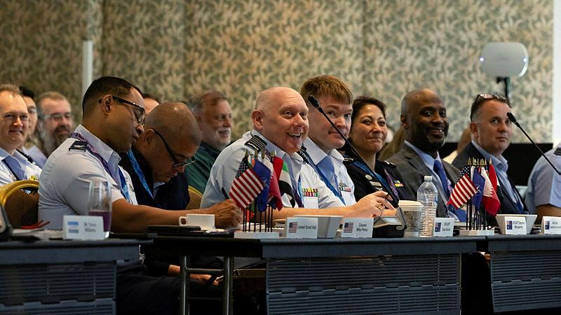 Group Captain Russell Barton (centre) sits alongside personnel from the United States Air Force and RAAF at the C-17 Virtual Fleet Conference in Brisbane. 