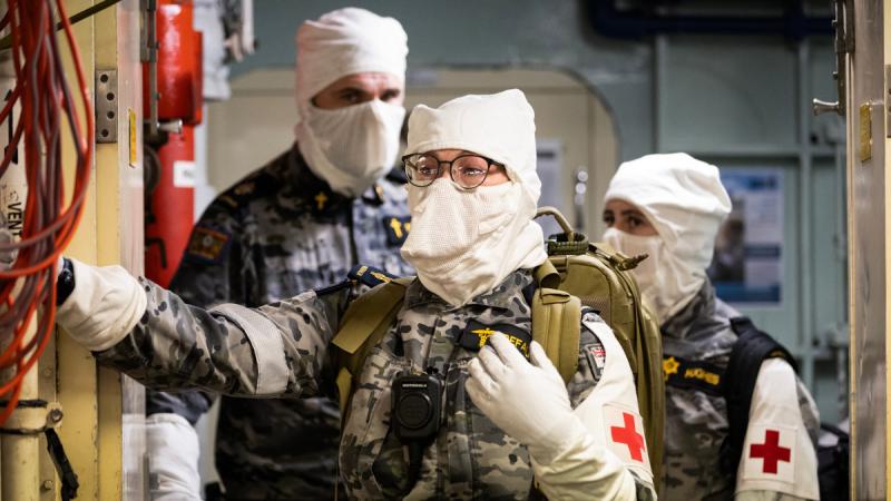 Able Seaman Medic Amanda Defalco awaits for a casualty handover as part of a crash on deck exercise.