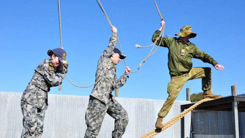 Australian Navy and Army Cadets work together to overcome the Leadership Reaction Course at Majura Range in Canberra.