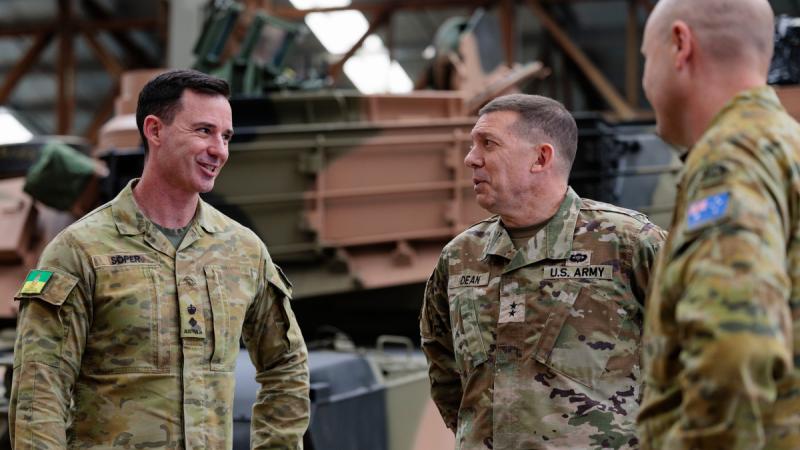 US Army Major General Glenn Dean, Program Executive Officer Ground Combat Systems, centre, speaks with Commanding Officer Army School of Electrical and Mechanical Engineering Lieutenant Colonel Tim Soper, left, during the Abrams M1A2 main battle tank maintainer course at Gaza Ridge Barracks, Bandiana, Victoria.