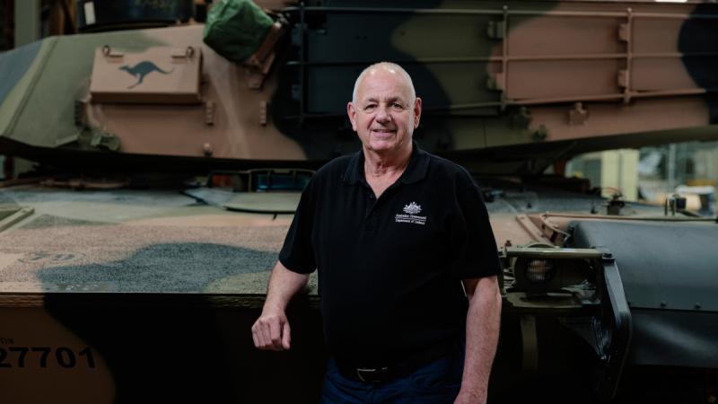Andrew McAdie stands with the new M1A2 main battle tank at Bandiana North Barracks, Victoria.