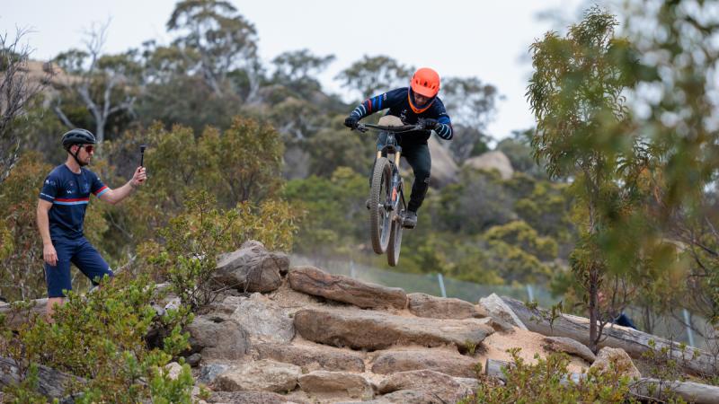 Leading Aircraftman Thomas Crigan jumps a rock obstacle in the gravity enduro race during the ADF National Cycling Carnival held at You Yangs Regional Park, Victoria.