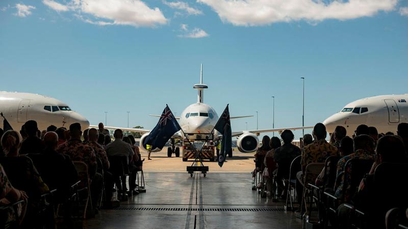 Attendees of a memorial service for the late Wing Commander Peter Krieg with a static display of E-7A Wedgetail aircraft at 2 Squadron, RAAF Base Williamtown. 