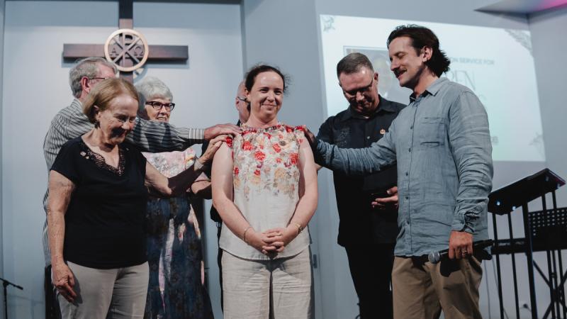 A prayer conducted during the ordination of Royal Australian Air Force Chaplain Karen Haynes (centre). Photos: Jonathan Lamprecht
