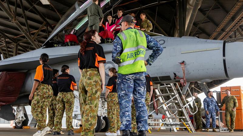 Leading Aircraftman Izak Ford explains some of the characteristics of a RAAF F/A-18F Super Hornet with a Defence Indigenous Youth Program participant at RAAF Base Amberley, Queensland. 