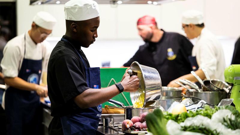 Seaman Valentine Mugabe prepares a dish during the Indo-Pacific Endeavour 2024 Cook-Off at @Sunrice Academy, Singapore. 