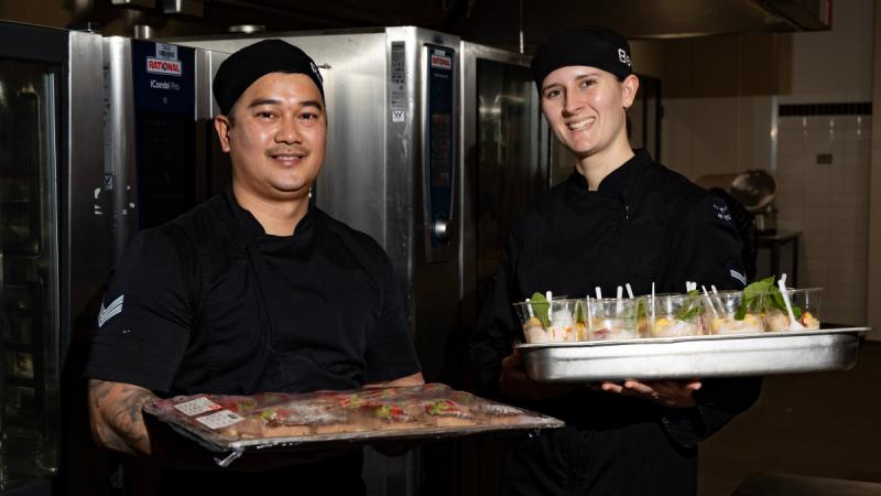 Air Force chefs Corporal Ray Wrobel, left, and Leading Aircraftwoman Rebecca Lowry wear the newly issued food handlers short and long sleeve coats at RAAF Base Amberley.