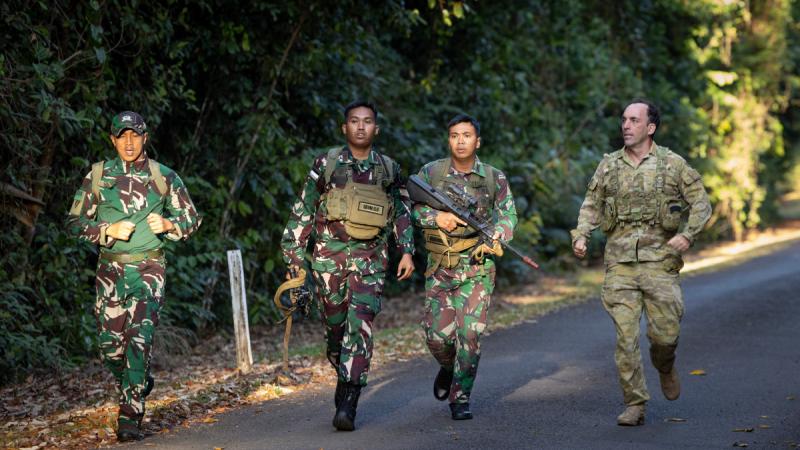 Indonesian Army soldiers (Tentara Nasional Indonesia) and Private Timothy Bernadt, right, participate in the True Grit challenge at the Junior Officer Combat Instructor Training Course held in Tully, Queensland.