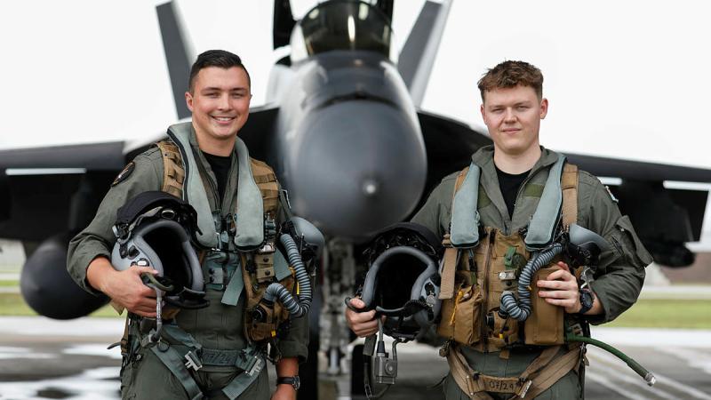 Two students involved in Exercise Crimson Dawn pre-flight with an F/A-18F Super Hornet at RAAF Base Townsville. 