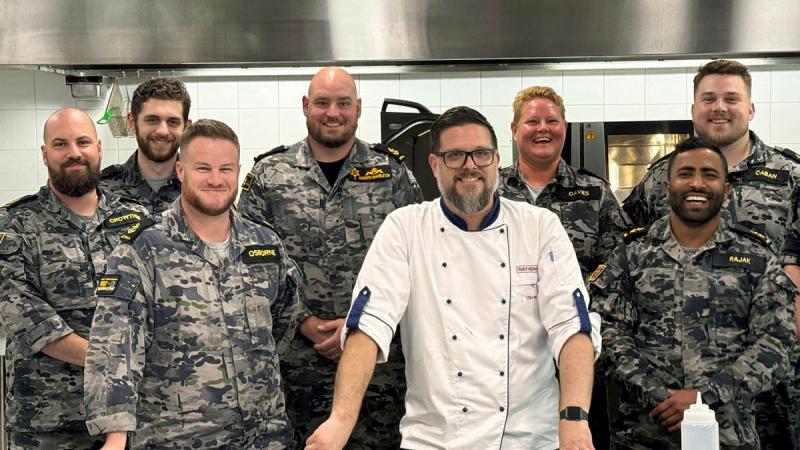Top-performing Navy chefs with a representative from manufacturer of kitchen technology, Rational.