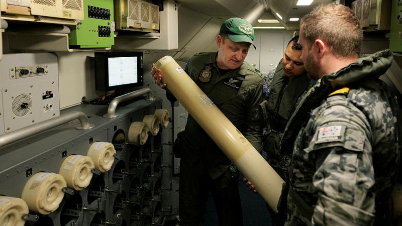  Warrant Officer Josh Rumis, left, of 11 Squadron, explains the capabilities of the P-8A Poseidon to a Malaysian observer during Operation Gateway. 