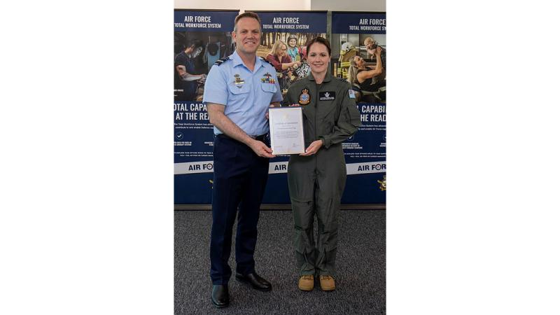 Chief of Air Force Air Marshal Stephen Chappell presents Group Captain Katherine Bennell-Pegg with her appointment into the Royal Australian Air Force Reserves during a ceremony in Canberra.
