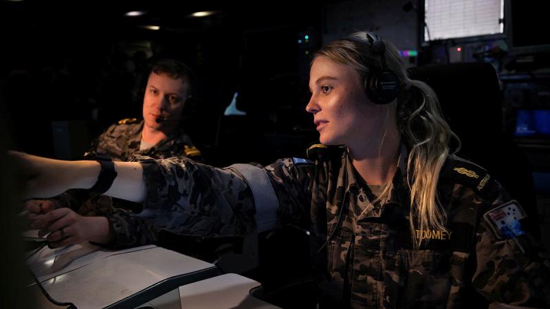 Able Seaman Combat Systems Operator Shimea Toomey, right, conducts training with Lieutenant Sabastian Chee in the ops room on board HMAS Ballarat at HMAS Stirling, WA. 