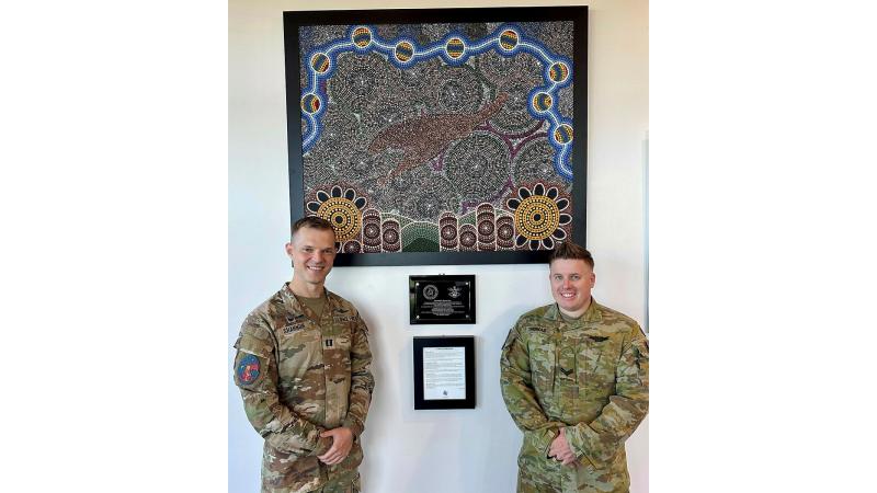 United States Space Force's Captain Nathaniel Shannon and Australian Army soldier Corporal Nathan Thomas with the Indigenous artwork "Celestial Harmony". 