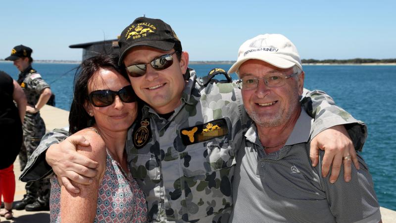Chief Petty Officer Matthew with his wife and father after HMAS Waller berths alongside Diamantina Pier at Fleet Base West. He has received a Conspicuous Service Medal during this year’s Australia Day honours and awards.
