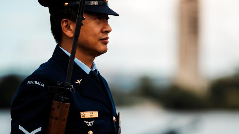 When not cooking aboard HMAS Brisbane, Leading Aircraftman Jin Seo is posted to the Australian Federation Guard in Canberra.