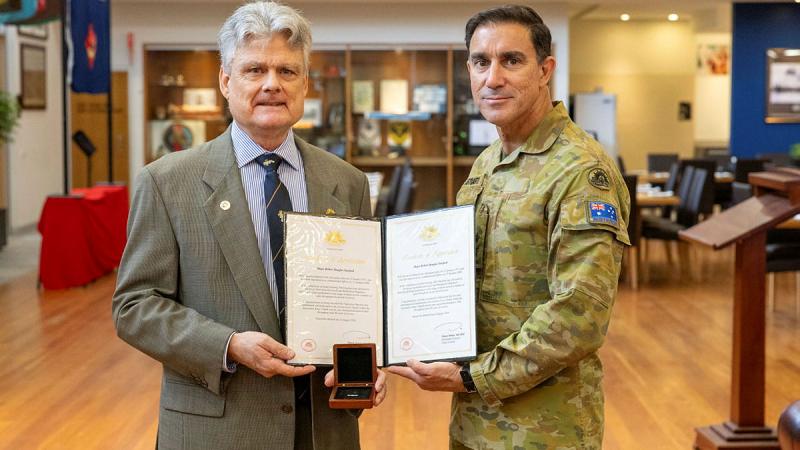 Australian Army officer Major Robert Sawford receives his second Federation Star from Lieutenant General Simon Stuart at Gallipoli Barracks, Brisbane. 