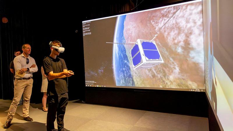 Participants of Exercise Western Dawn experience The 90° Wedge, a 3.8-metre diagonal 3D display at the HIVE (Hub for Immersive Visualisation and eResearch) at Curtin University, Perth. 