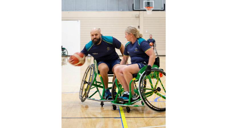 Invictus Games 2025 Team Australia competitor Sue Osborn attempts to tackle Torben Louwen-Skovdam, left, during a wheelchair basketball training session at the Australian Institute of Sport, Canberra.