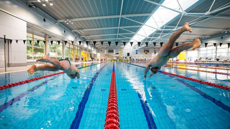 Invictus Games 2025 Team Australia competitors Callan Mclean, right, and Jake Christie, left, dive in to the pool for a time trial during a training camp at the Australian Institute of Sport in Canberra. 