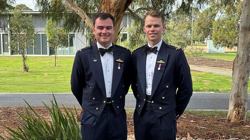 (L to R) Brothers and RAAF pilots, Flying Officer Samuel Hughes and Flying Officer Luke Hughes, celebrate both earning their wings at the 1 Flying Training School Course 278 ADF Intermediate Pilots’ Course Graduation at RAAF Base East Sale. 
