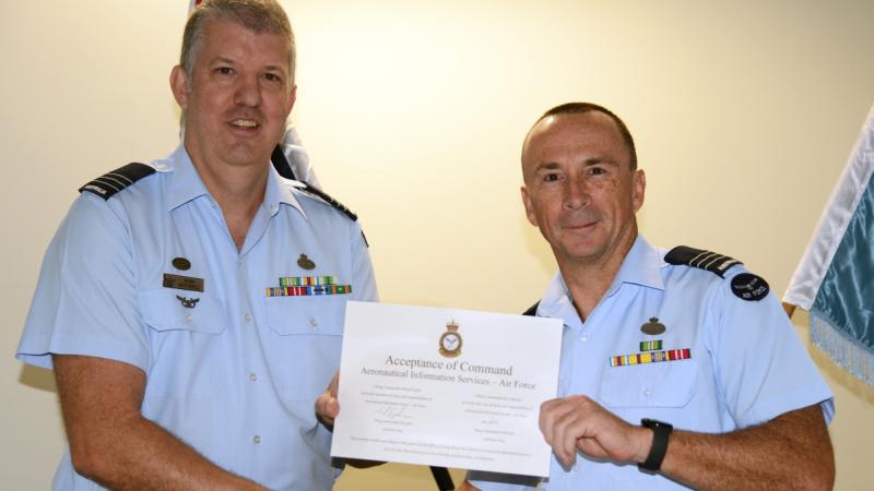 Wing Commander Ross Mitchell, left, accepts command of Aeronautical Information Service – Air Force from Wing Commander Michael Lyden at the change of command ceremony, Victoria Barracks, Melbourne.