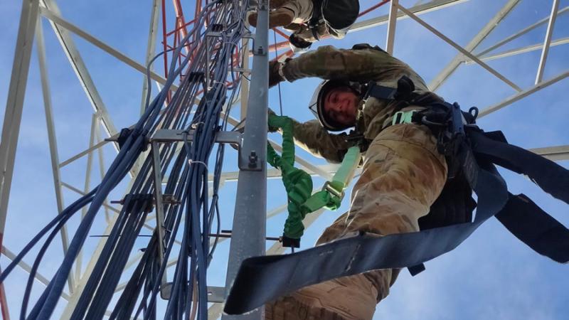 Australian Army officer Captain Natasha Kirkham climbs a radio tower during a deployment to repair and upgrade the Vanuatu Government National Emergency Radio Network.