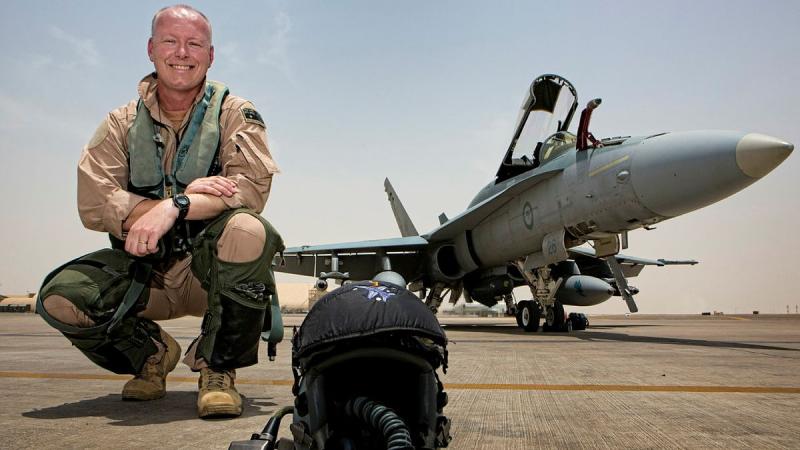 Commander Air Task Group, Air Commodore Philip Gordon, in front of an F/A-18A Hornet on the flight line of Australia's main air operating base in the Middle East region. 