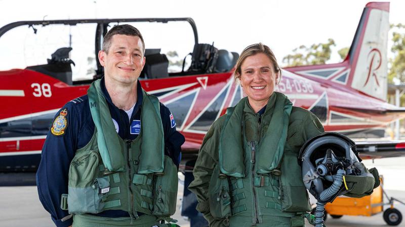 Roulette Two, Flight Lieutenant David Burnard, stands with Tour Down Under assistant race director Carlee Taylor in front of a PC-21 aircraft before their flight..