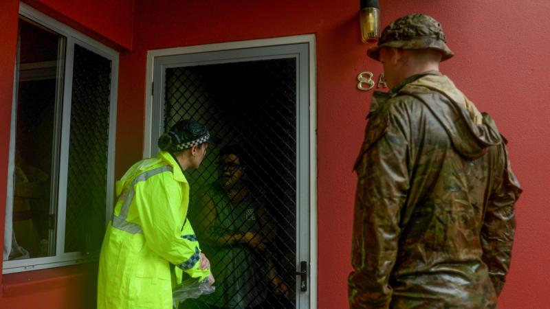 Soldiers from 3rd Battalion, Royal Australian Regiment, support the Queensland Police Service with door-knocking during severe weather in Townsville.