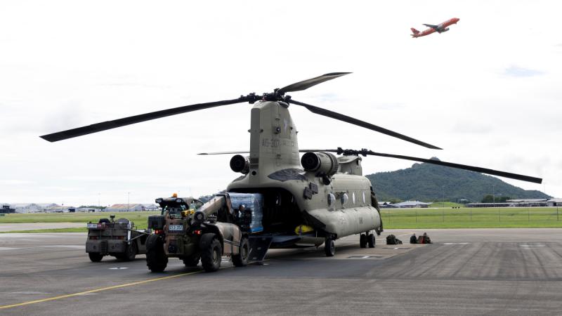 Army personnel from 5th Aviation Regiment load stores into a CH-47F Chinook in support of the North Queensland flood relief efforts.