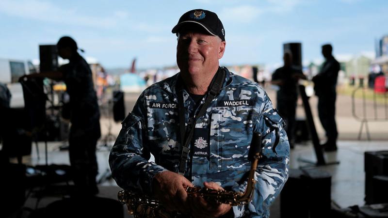 Warrant Officer in Charge of the Air Force Band, Sydney Detachment, Warrant Officer Ian Waddell, sitting with saxophone, at the Hunter Valley Air Show, Cessnock, NSW. 