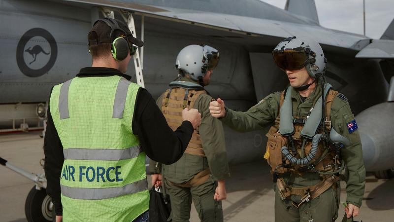 A RAAF 1 Squadron F/A-18F Super Hornet pilot, weapons systems officer and ground crew member meet for pre-flight checks during Exercise Red Flag Nellis 25-1 in Nevada, US.