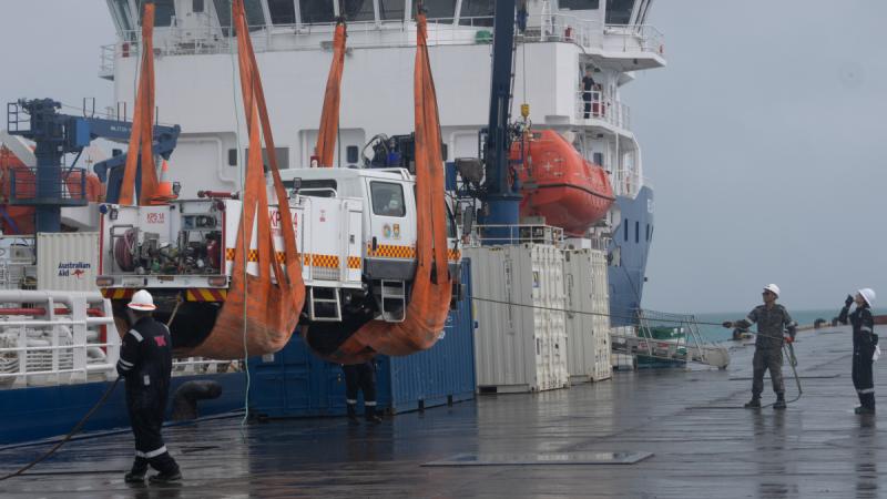 ADV Reliant crew offload the donated fire truck onto the dock at Betio Port, Tarawa, Kiribati.