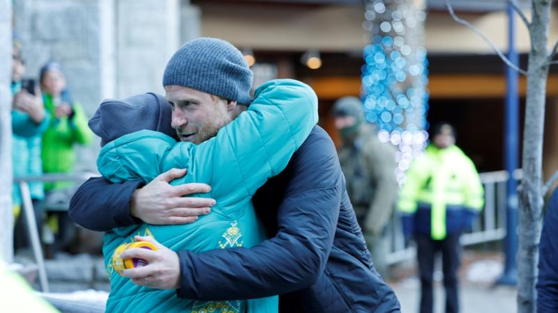 Squadron Leader Belinda Culley receives a hug from Prince Harry, the Duke of Sussex after gifting him a jar of Vegemite at Invictus Games Vancouver Whistler 2025 
