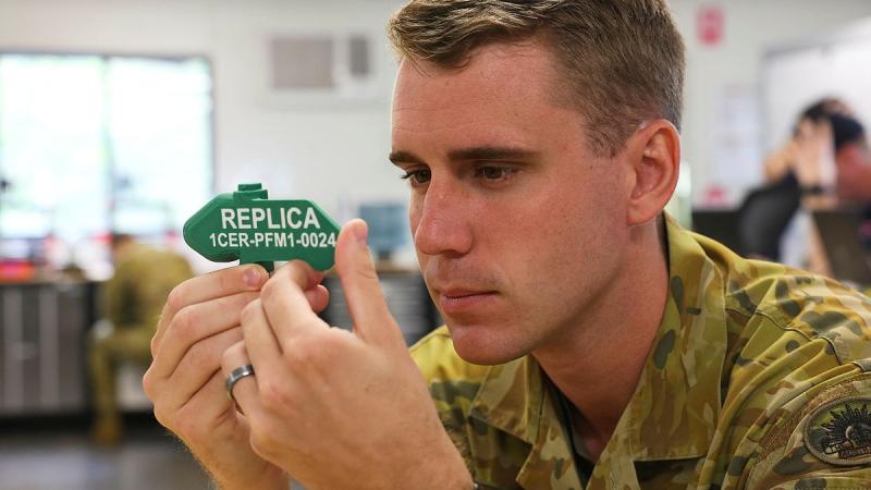 Australian Army combat engineer Lance Corporal Doug Shellcot with a 3D-printed replica PFM-1 butterfly mine he produced at the Robertson Barracks MakerSpace.