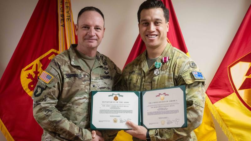 Australian Army officer Major Michael Parry, right, is congratulated by US Army officer Brigadier General Patrick Costello on being awarded the US Army Commendation Medal and Meritorious Service Medal for his work as the plans officer at the US Army’s 94th Army Air and Missile Defence Command in Hawaii.