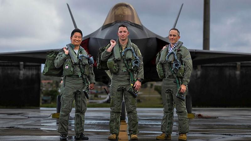 Japan Air Self-Defense Force pilot Captain Nakanishi, United States Air Force pilot Lieutenant Mike Watson and Royal Australian Air Force pilot Flight Lieutenant Ryan Turner in front of an F-35A Lightning II during Exercise Cope North 25 at Andersen Air Force Base, Guam.