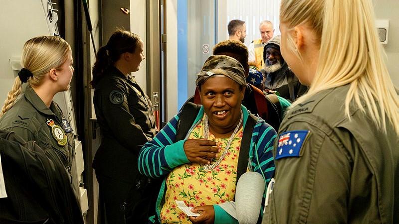 The crew of a Royal Australian Air Force KC-30A welcome passengers on board at Ben Gurion Airport, Tel Aviv, for an assisted-departure flight as part of Operation Beech.