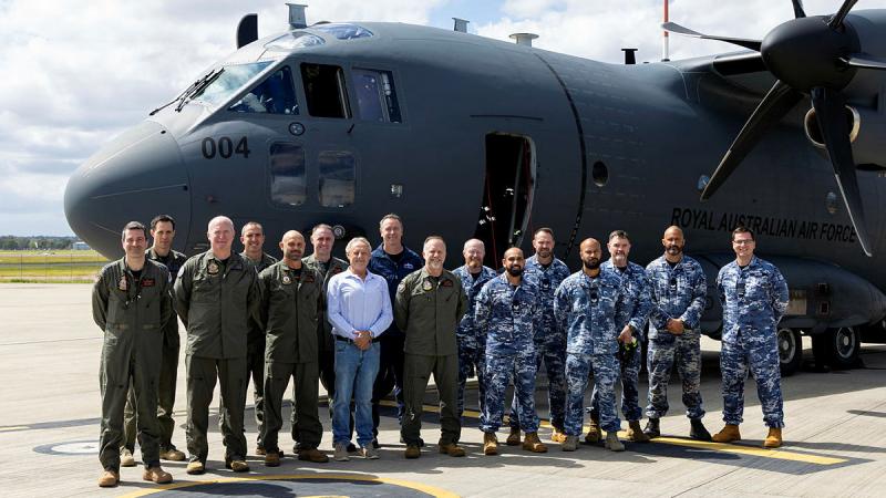 The flight crew and passengers in front of a C-27J Spartan prior to departing for the 10th anniversary of flying operations flight at RAAF Base Amberley.