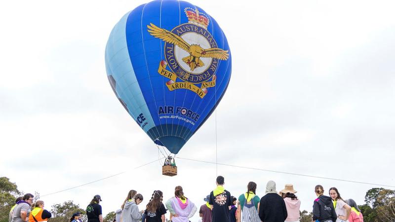 Families at the Very Special Kids Camp line-up for their flight in the Air Force Balloon.