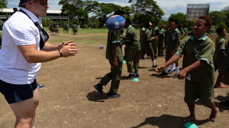 Australian Army Trooper Lachlan Ireland instructs at an Australian Football League (AFL) skills workshop for students of Ted Diro Primary School in Port Moresby, during an Australian Defence Force sports training program in Papua New Guinea. Photo by CPO Paul Berry. 