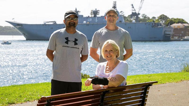 Able Seaman Bharatkumar (Brett) Thumar, left, and Leading Seaman Chris Hughes reunite with Liz Cummings for the first time since providing first aid to her in the Royal Botanic Garden, Sydney. 