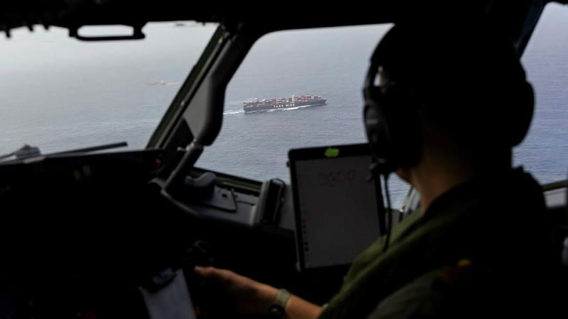 Royal Australian Navy pilot Lieutenant Jure Plestina observes a vessel from a Royal Australian Air Force P-8A Poseidon aircraft during a coordinated maritime domain awareness activity in the South China Sea. 