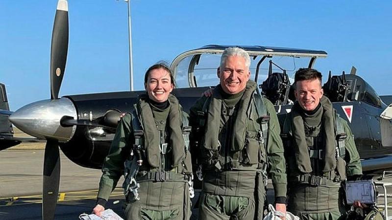 Pilot Officer Astrid Streeter-Smith and Pilot Officer Zack Burton return from a sortie with Group Captain Scott Woodland, Air and Space Liaison at the Australian High Commission in London.